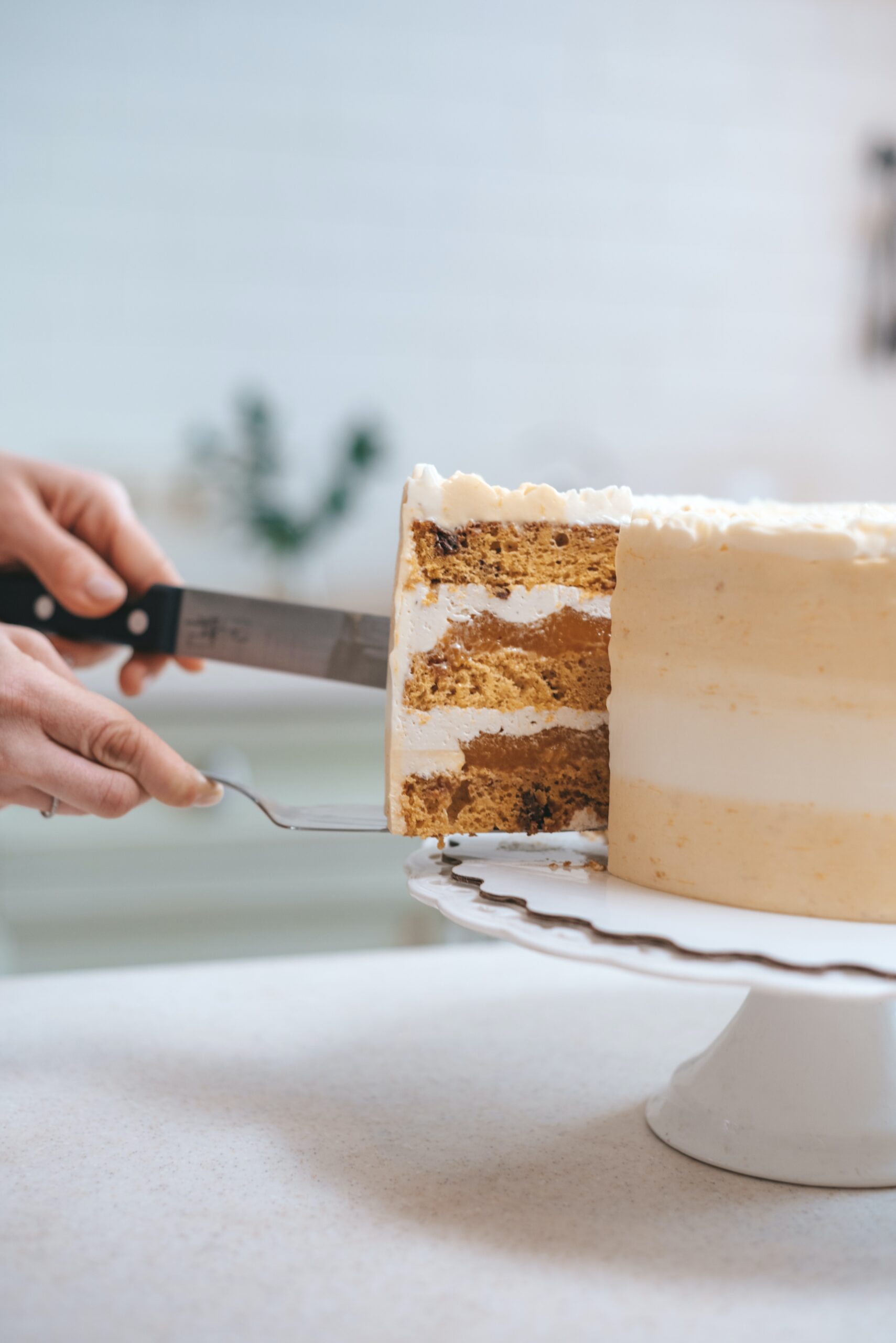 anonymous confectioner cutting the sweet cake