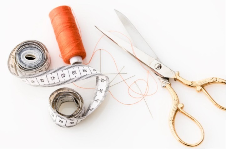 An Image Displaying Golden Scissor and Thread