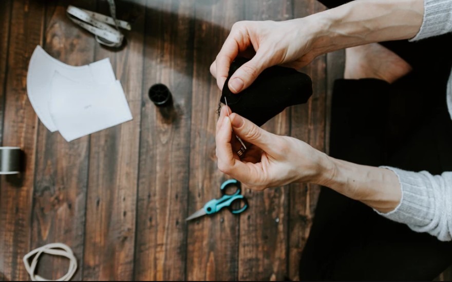 hands with needle sewing