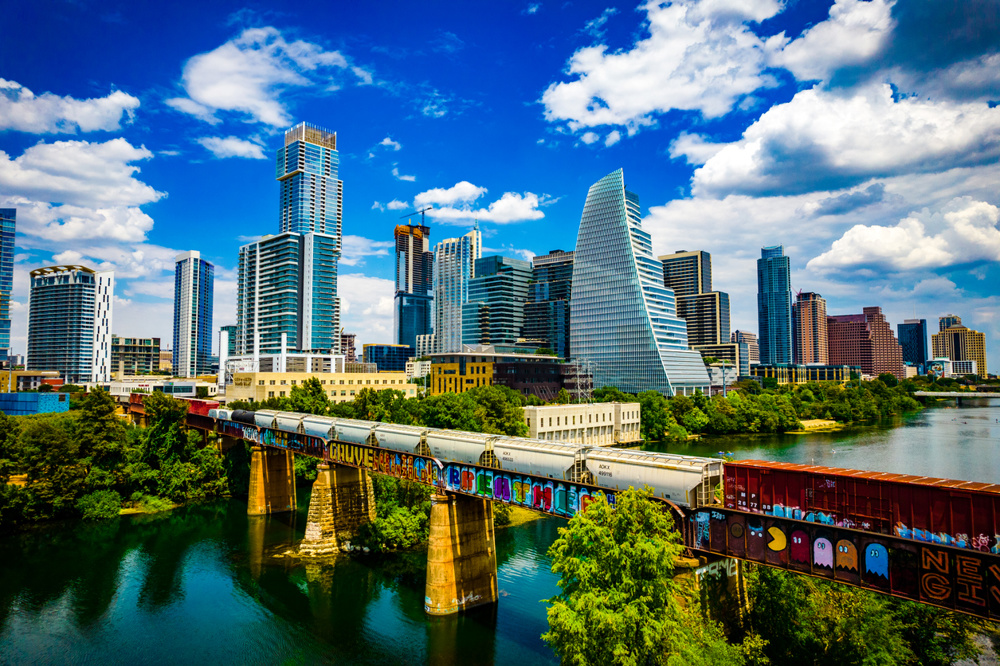 Aerial drone view over Austin along the Colorado River or Lady Bird Lake with the city skyline in the background