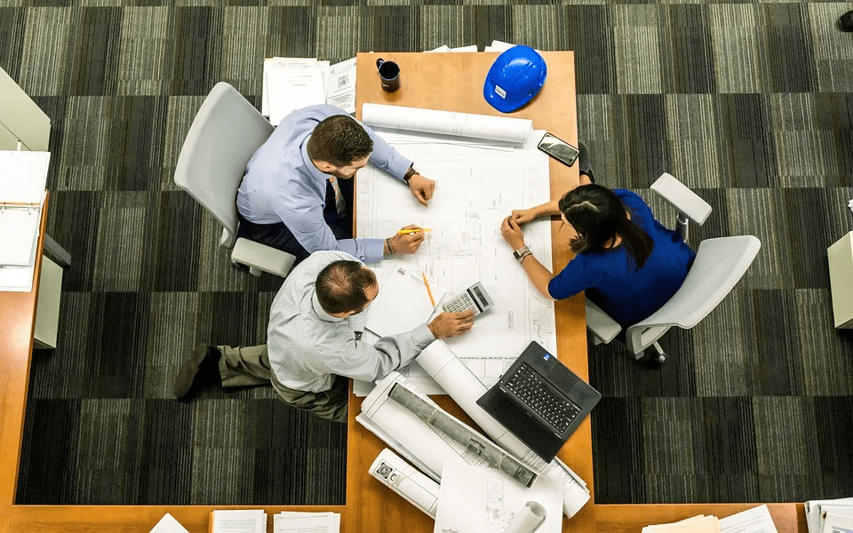 three people shares a work table