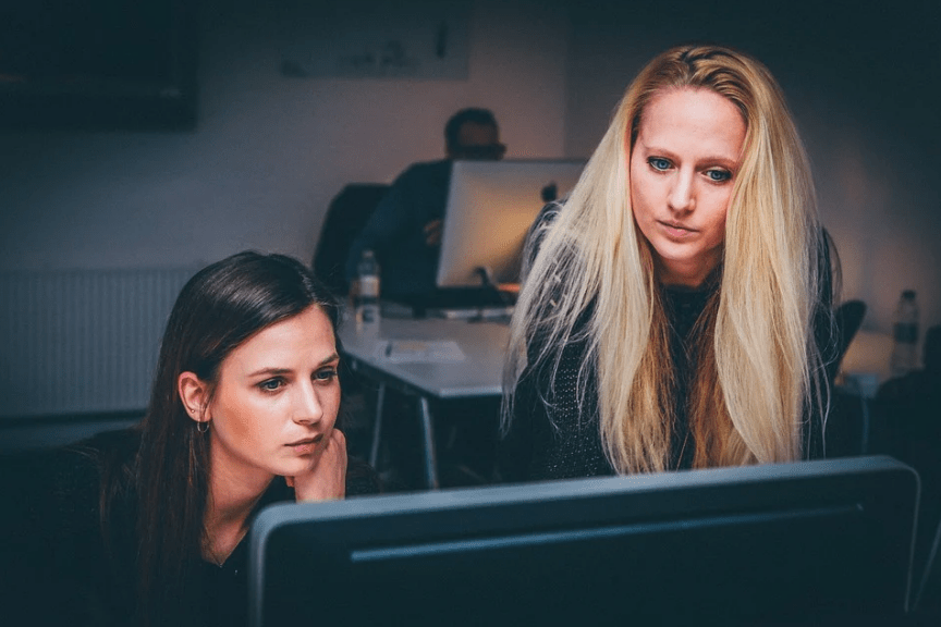 2 women working and looking on a PC