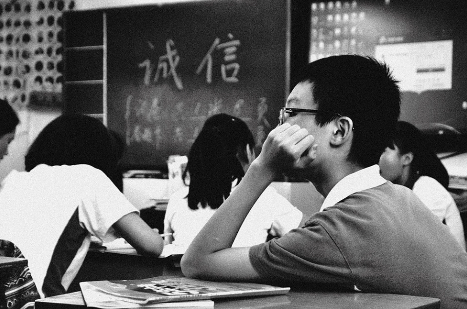 sad kid sitting in his classroom