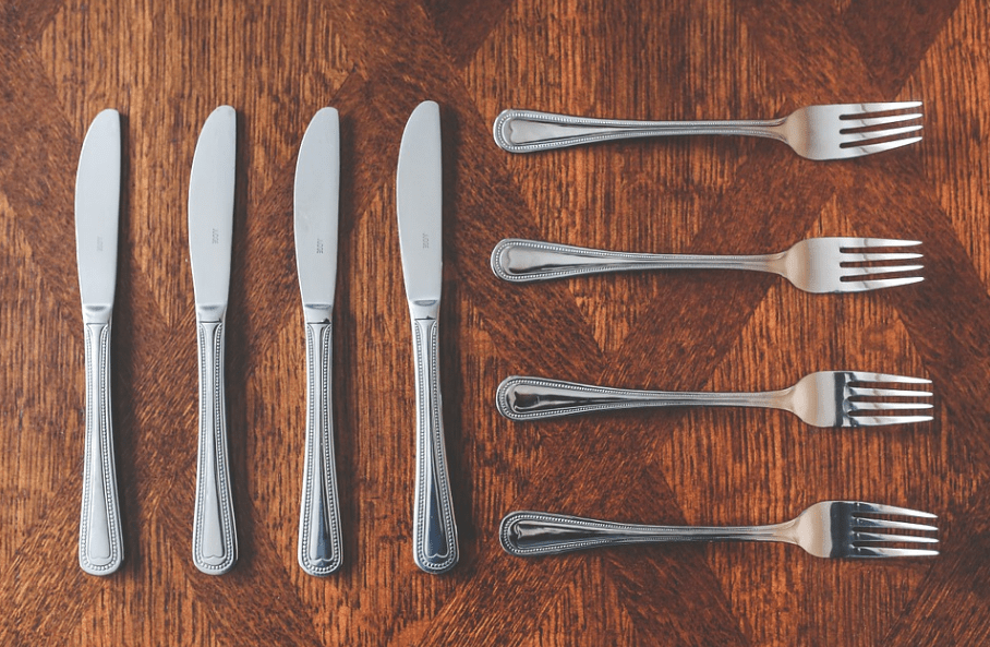 knives and forks on a brown table