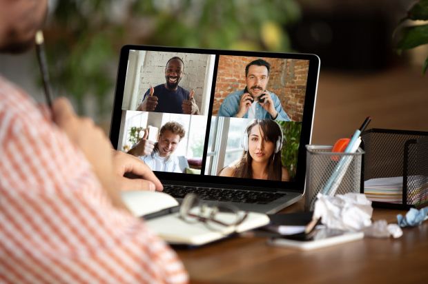 Picture of a man attending a virtual conference with his colleagues