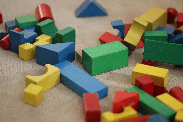 green, blue, yellow, and red building blocks, dirty white carpet