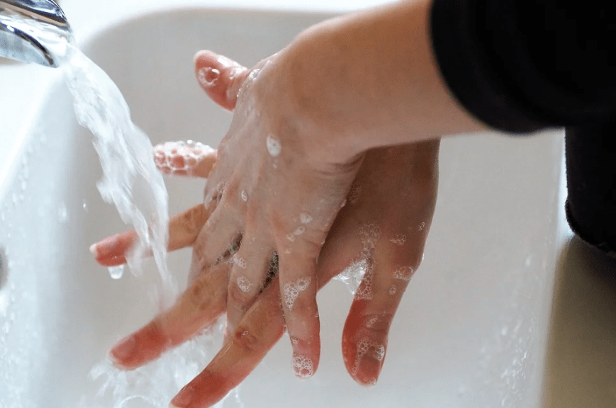 hands washing with soap and a running water from the faucet