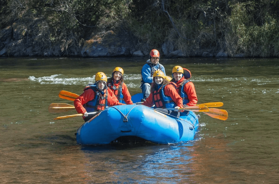 five adults on a raft boat