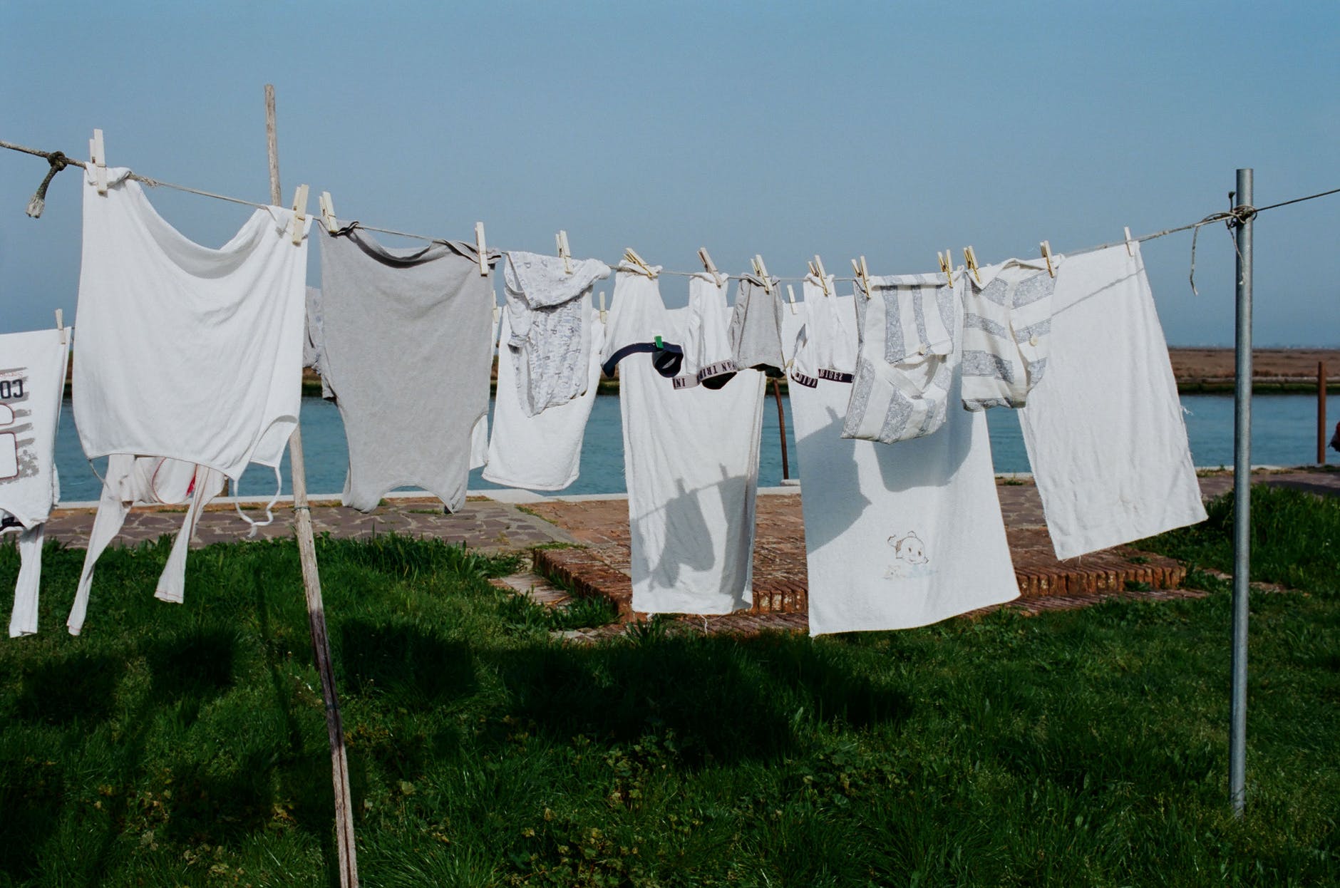linen hanging on clothesline on grassy seacoast