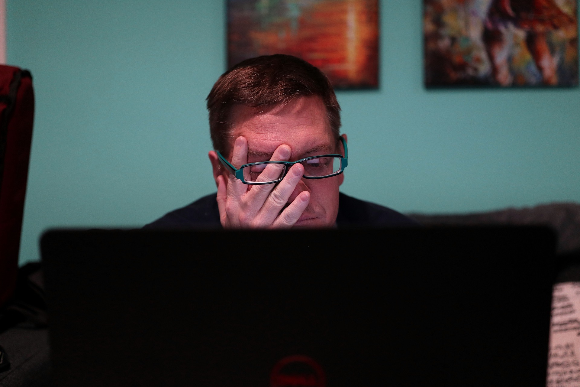 tired man facing the laptop screen