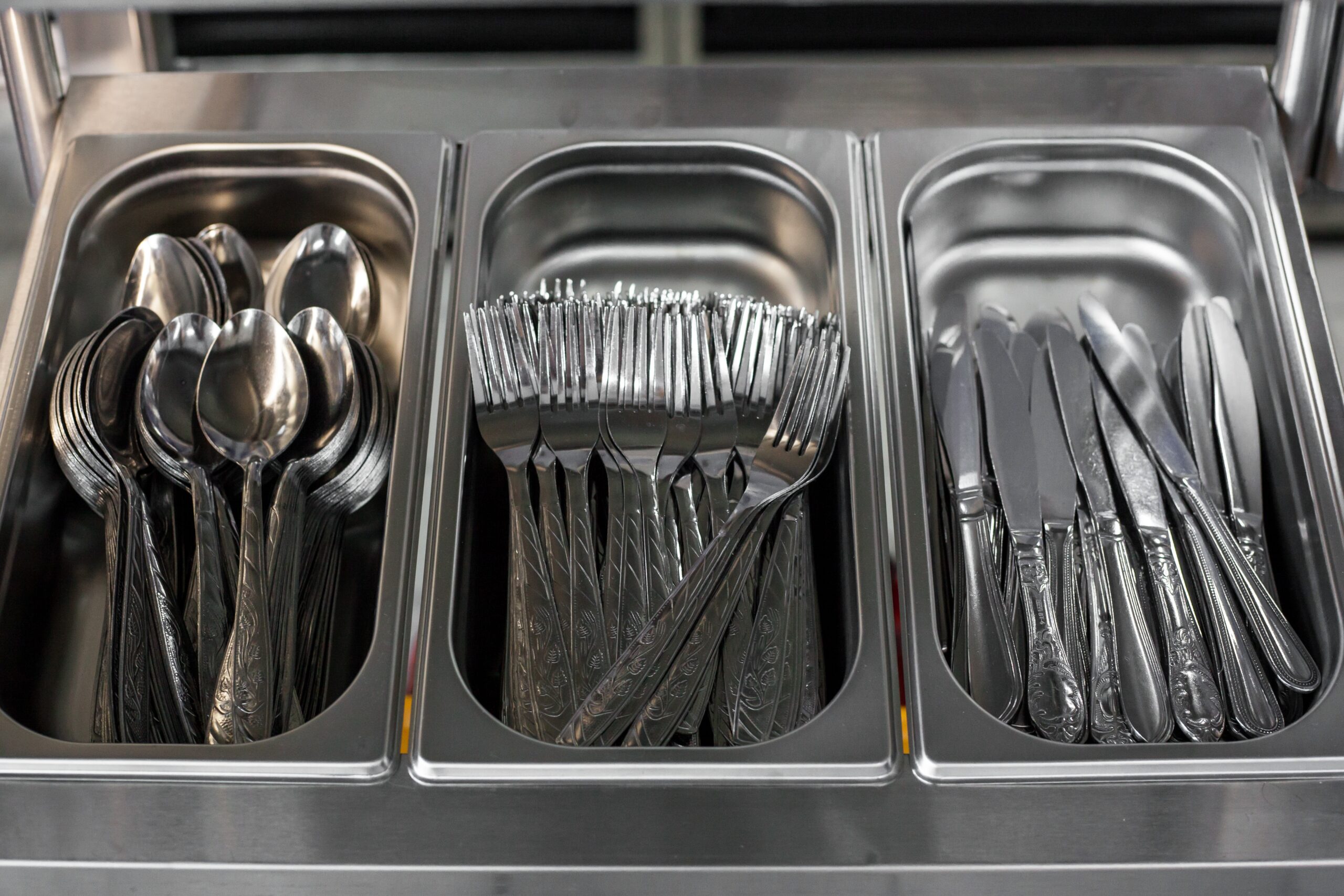 a set of kitchen utensils in metal containers