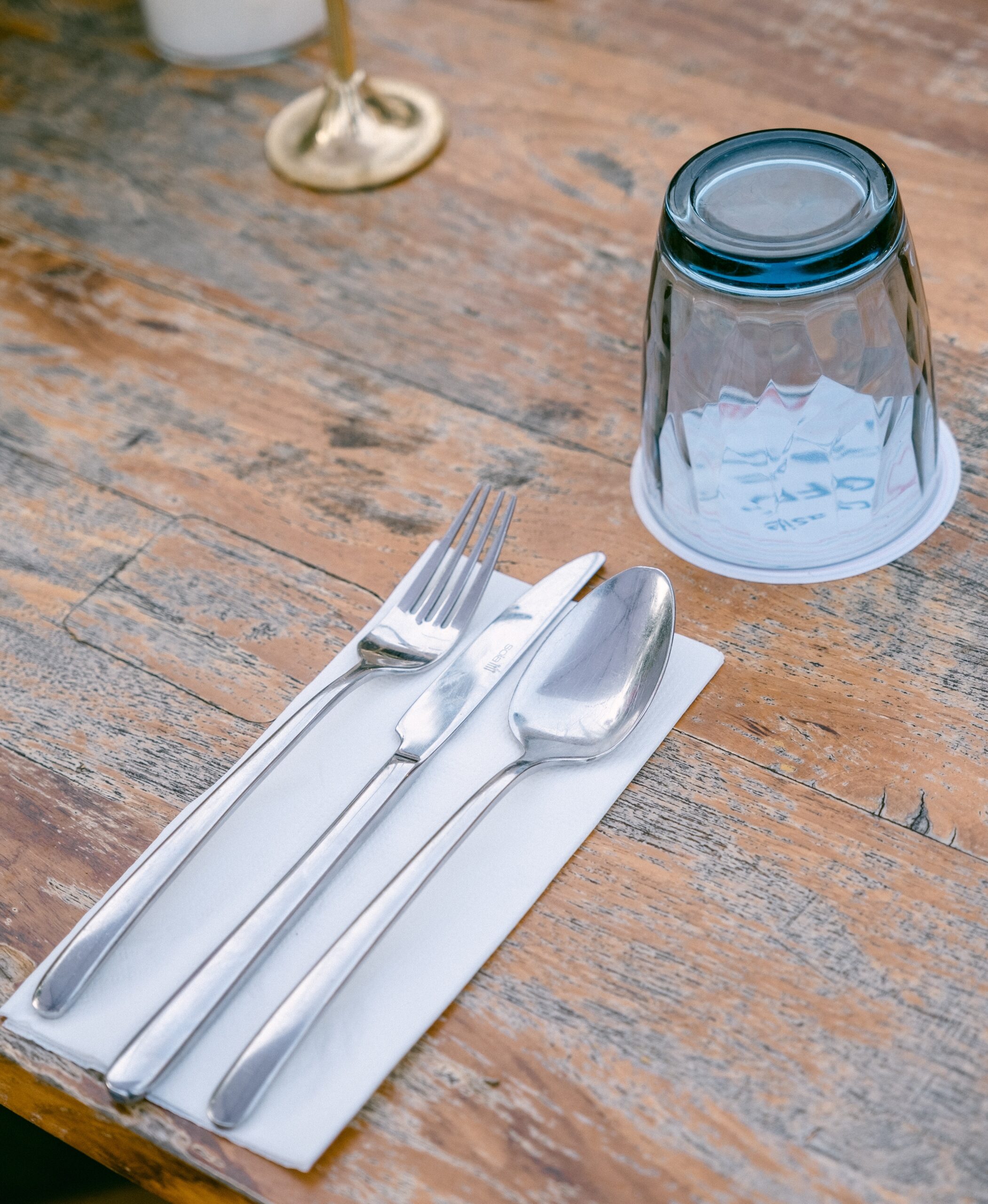 cutlery and glass on a wooden table